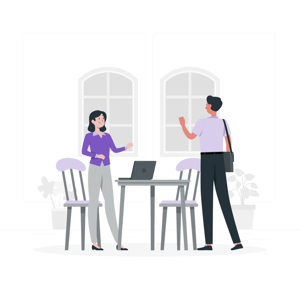 A man and a woman engaging in a professional discussion inside an office.